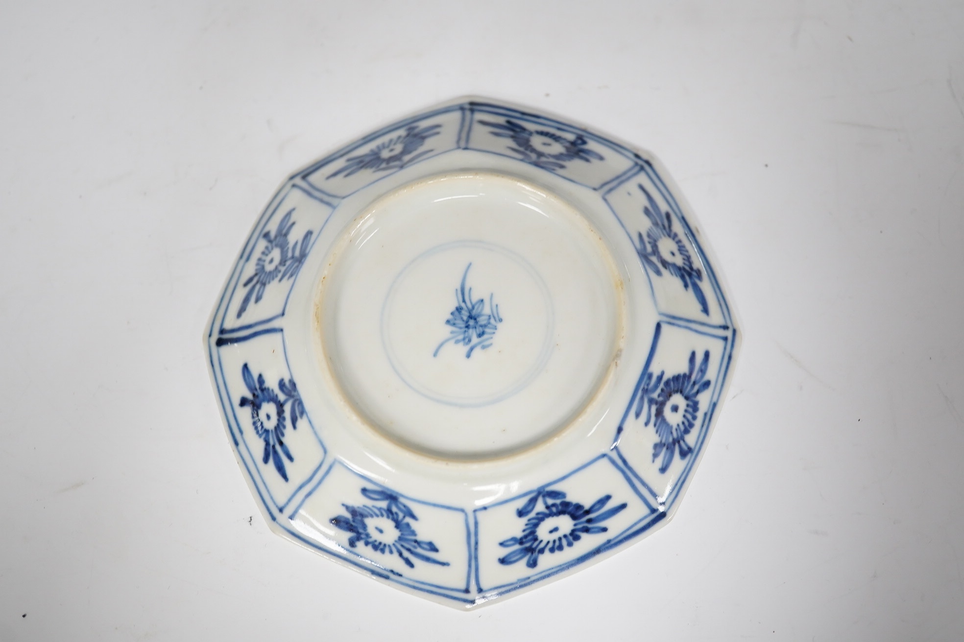 A Chinese blue and white octagonal saucer dish, Kangxi period, with stand, 9.5cm in diameter. Condition - good